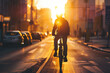 Male biker riding a bicycle at early morning on a city street.