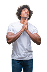 Canvas Print - Afro american man over isolated background begging and praying with hands together with hope expression on face very emotional and worried. Asking for forgiveness. Religion concept.