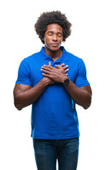 Sticker - Afro american man over isolated background smiling with hands on chest with closed eyes and grateful gesture on face. Health concept.