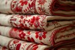 © Natalia - Stack of traditional Hungarian embroidered textiles featuring intricate red floral patterns