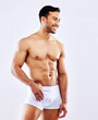 Man, smile and muscle in underwear on studio, white background or bodybuilder thinking mockup. Healthy, athlete and stomach of model with abs from fitness with exercise and workout at gym aesthetic
