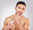 Portrait, man and perfume in studio with skincare or grooming for self care, scent and natural cosmetics for face. Fresh, isolated and white background with fragrance cologne for aftershave routine.