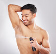 Happy, man and spray in studio for hygiene or grooming for self care, wellness and natural cosmetics for scent. Person, isolated and white background with fragrance perfume for fresh armpits.