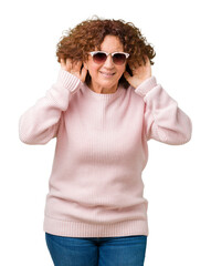 Poster - Beautiful middle ager senior woman wearing pink sweater and sunglasses over isolated background Trying to hear both hands on ear gesture, curious for gossip. Hearing problem, deaf