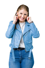 Sticker - Beautiful middle age mature woman wearing fashion leather jacket over isolated background covering ears with fingers with annoyed expression for the noise of loud music. Deaf concept.