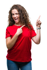 Poster - Beautiful brunette curly hair young girl wearing casual look over isolated background smiling and looking at the camera pointing with two hands and fingers to the side.