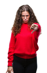 Wall Mural - Beautiful brunette curly hair young girl wearing glasses and winter sweater over isolated background looking unhappy and angry showing rejection and negative with thumbs down gesture. Bad expression.