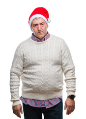 Sticker - Handsome senior man wearing christmas hat over isolated background depressed and worry for distress, crying angry and afraid. Sad expression.