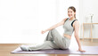 Cheerful active woman doing fitness at home