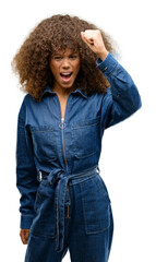 African american woman wearing blue jumpsuit irritated and angry expressing negative emotion, annoyed with someone