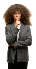 Sticker - African american business woman wearing glasses asking to be quiet with finger on lips. Silence and secret concept.