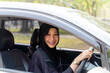 Closeup a beautiful Muslim woman in Abaya niqab traditional clothes driving a car in city
