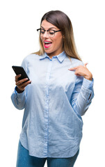 Poster - Young beautiful business woman texting message using smartphone over isolated background with surprise face pointing finger to himself