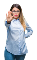 Wall Mural - Young beautiful business woman wearing glasses over isolated background doing stop sing with palm of the hand. Warning expression with negative and serious gesture on the face.
