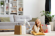 Happy Young Woman With Shopping Bags Relaxing At Home, Enjoying Online Shopping Success, Casual Lifestyle In Modern Apartment