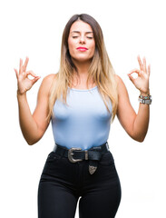 Sticker - Young beautiful elegant business woman over isolated background relax and smiling with eyes closed doing meditation gesture with fingers. Yoga concept.