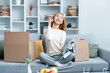 Young Woman Unpacking Boxes, Smiling Joyfully While Talking On Phone, Modern Living Room Setting, Online Shopping Concept, Happy, Lifestyle
