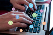 © Stanisic Vladimir - Hands typing on laptop keyboard with levitating icons: credit card, shop, money, discount. Concept of seamless online shopping experience