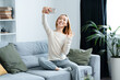 Happy Young Woman Taking Selfie On Smartphone At Home, Cheerful And Relaxed, Modern Interior