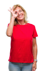 Sticker - Middle age blonde woman over isolated background doing ok gesture with hand smiling, eye looking through fingers with happy face.