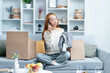 Young Woman Enjoying Unboxing Shopping Finds At Home, Expressing Joy And Satisfaction While Talking On The Phone, Trendy Indoor Setting