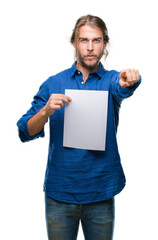 Sticker - Young handsome man with long hair over isolated background holding blank paper pointing with finger to the camera and to you, hand sign, positive and confident gesture from the front