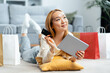 Happy Young Woman Shopping Online At Home, Holding Credit Card And Digital Tablet With Shopping Bags Around, Comfortable E-commerce Experience
