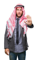 Sticker - Young handsome arabian man with long hair wearing keffiyeh over isolated background doing stop sing with palm of the hand. Warning expression with negative and serious gesture on the face.