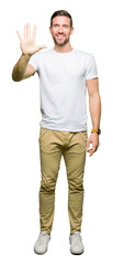 Poster - Handsome man wearing casual white t-shirt showing and pointing up with fingers number five while smiling confident and happy.