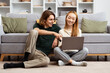 Happy Couple Enjoying Time Together At Home, Young Man And Woman Sitting On Floor Using Laptop In Cosy Living Room, Relaxed Lifestyle