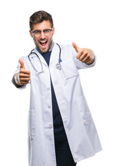 Poster - Young handsome doctor man over isolated background approving doing positive gesture with hand, thumbs up smiling and happy for success. Looking at the camera, winner gesture.