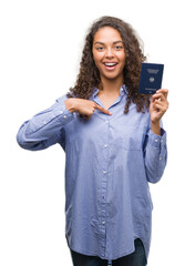 Poster - Young hispanic woman holding passport of Germany with surprise face pointing finger to himself