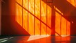 An orange wall with sunlight shining through the windows.