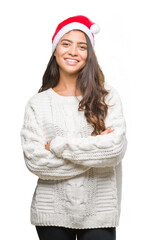 Sticker - Young arab woman wearing christmas hat over isolated background happy face smiling with crossed arms looking at the camera. Positive person.