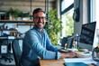 © shelbys - A cheerful man working on a computer at his office desk. Fictional Character Created By Generative AI.