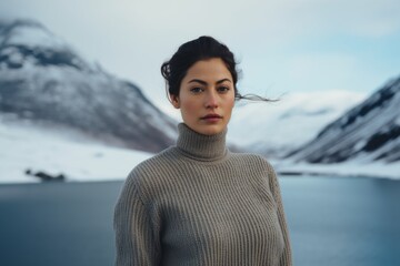 Wall Mural - Portrait of a merry woman in her 30s wearing a classic turtleneck sweater while standing against backdrop of an arctic landscape