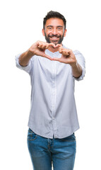 Wall Mural - Adult hispanic man over isolated background smiling in love showing heart symbol and shape with hands. Romantic concept.