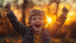 Joyful toddler celebrating with arms raised in autumn sunset