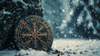 Ancient Nordic Viking symbols on a shield in a snowy forest landscape
