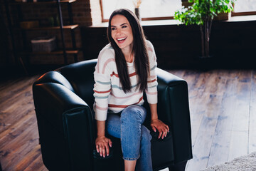 Poster - Photo of lovely young woman sit armchair relaxed look empty space wear striped outfit interior home living room in brown warm color