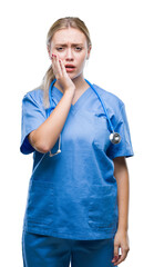 Wall Mural - Young blonde surgeon doctor woman over isolated background touching mouth with hand with painful expression because of toothache or dental illness on teeth. Dentist concept.