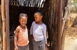 two village african girls with braids standing at the entrance of the shack, township village in south africa