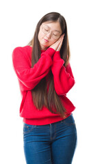 Poster - Young Chinese woman over isolated background wearing glasses sleeping tired dreaming and posing with hands together while smiling with closed eyes.