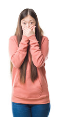 Wall Mural - Young Chinese woman over isolated background wearing sport sweathshirt shocked covering mouth with hands for mistake. Secret concept.