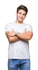 Wall Mural - Young handsome man wearing white t-shirt over isolated background happy face smiling with crossed arms looking at the camera. Positive person.