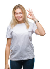 Poster - Young caucasian woman over isolated background smiling positive doing ok sign with hand and fingers. Successful expression.