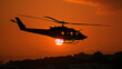 A helicopter is flying in the sky at sunset
