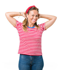 Poster - Beautiful middle age woman wearing casual stripes t-shirt over isolated background Relaxing and stretching with arms and hands behind head and neck, smiling happy