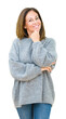 © Krakenimages.com - Beautiful middle age woman wearing winter sweater over isolated background looking confident at the camera with smile with crossed arms and hand raised on chin. Thinking positive.