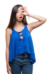 Poster - Young asian woman over isolated background doing ok gesture shocked with surprised face, eye looking through fingers. Unbelieving expression.